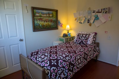 Cozy resident room with bed and artwork