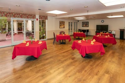 Dining room set up with red tablecloths and decorations