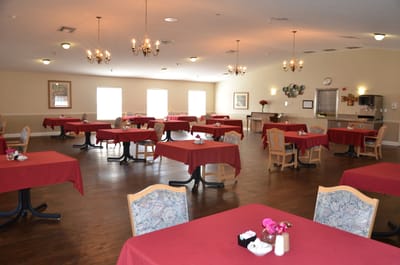 Empty dining room with red tablecloths and chandeliers