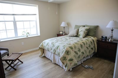 A cozy private resident room with a bed and window