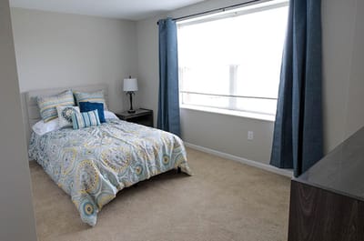 A well-furnished private bedroom with window