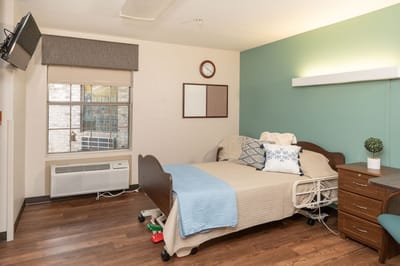 Cozy resident room with bed and window view