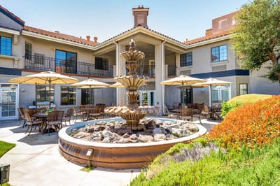 Outdoor courtyard with fountain and seating area