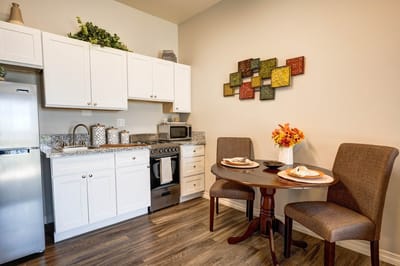 Cozy kitchenette in a resident unit with dining table