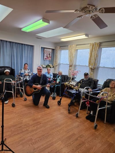Residents enjoying a music activity in a common area