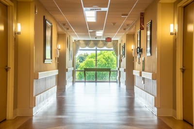 Bright hallway with large windows and view of greenery