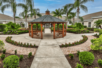 An outdoor gazebo surrounded by beautiful landscaping