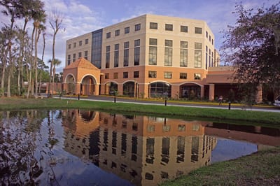 Exterior view of a nursing home building with reflection in the water
