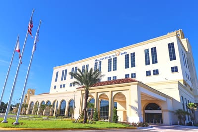 Exterior view of Halifax Health facility with flags