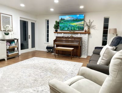 Bright common area with seating and piano