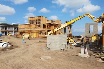 Construction of a new building with workers and machinery