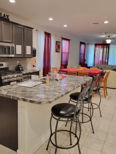 Interior view of a common area with kitchen and seating