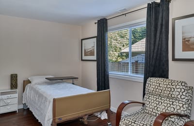 Private resident room with a bed and chair