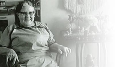 Resident sitting in a common area with decor items