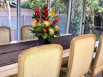 Dining area with floral arrangement and bright decor