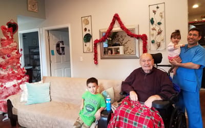 Residents and staff in a cozy living room setting