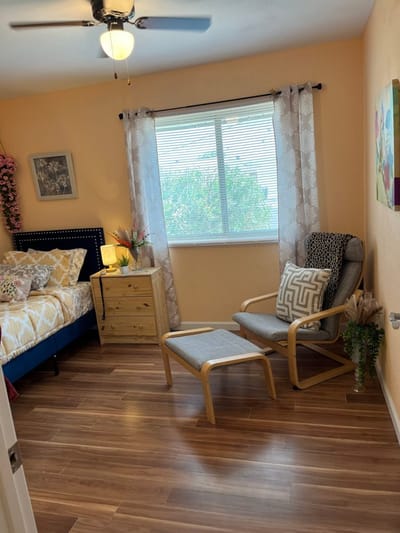 Cozy room with bed, chair, and window light