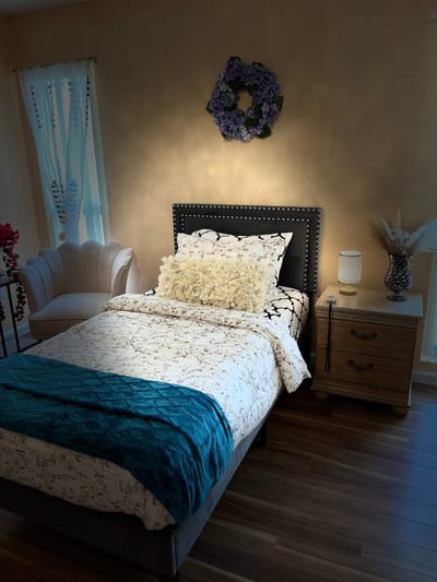 Cozy private resident room with a bed and decorative elements