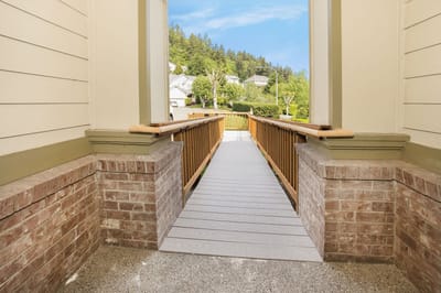 View of a wooden bridge leading to a garden area
