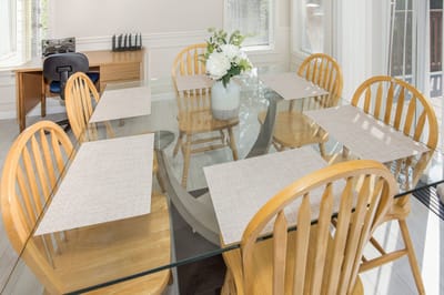 Bright dining room with wooden chairs and table