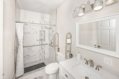 Modern bathroom with grab bars and marble accents