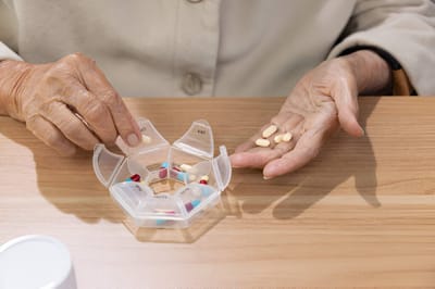 Resident managing medication with a pill organizer