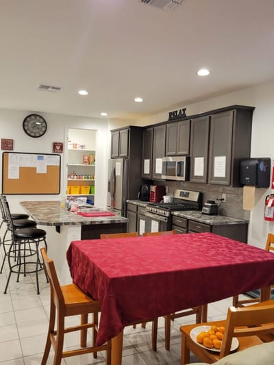 Interior view of a kitchen area with a red tablecloth