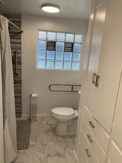 Bright bathroom with modern fixtures and glass block window