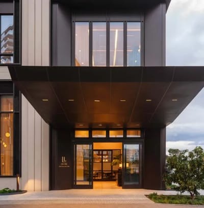 Modern entrance of a senior living facility with a covered area