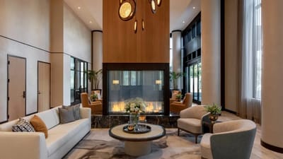 Modern lobby area with seating and a fireplace