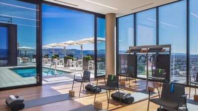 Well-lit fitness room with a view of the pool