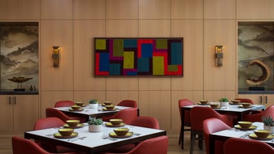 Dining area with modern decor and vibrant artwork