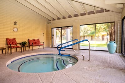 Indoor spa area with seating and hot tub