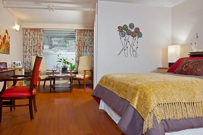 Cozy resident room with bright decor and seating area