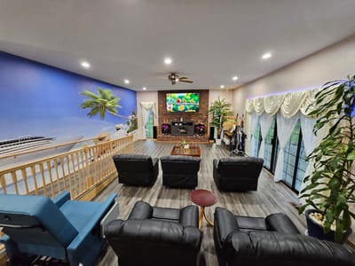 Interior view of a common area with seating and a large TV