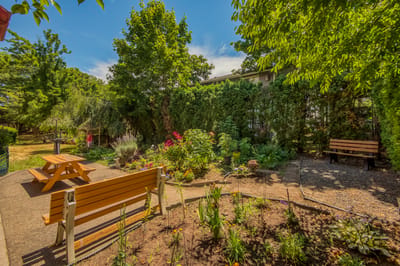Peaceful garden area with benches and flowers