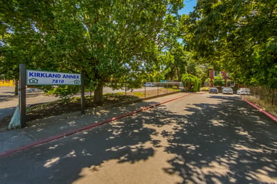 Entrance sign for Kirkland Annex surrounded by trees