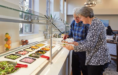Residents enjoying a meal at a buffet service