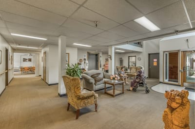 Interior view of a common area with residents and seating