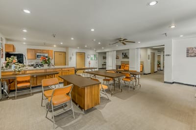 Common area with tables and chairs in an interior setting