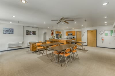 Bright common area with tables and chairs for activities