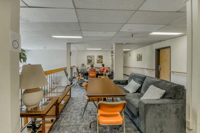 Interior common area with residents engaged in conversation