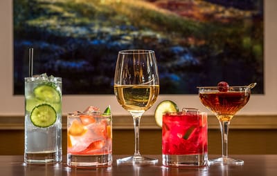 Five colorful cocktails on a table