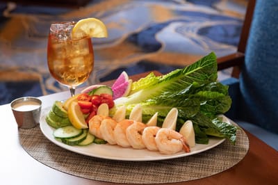 Plated shrimp with lettuce and vegetables on a table