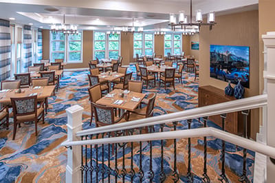 Dining room with tables and chairs set for meals