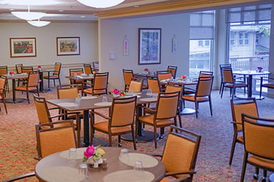 Bright dining room with tables set for meals