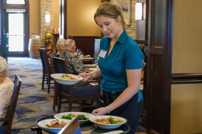 Staff serving meals in a dining area