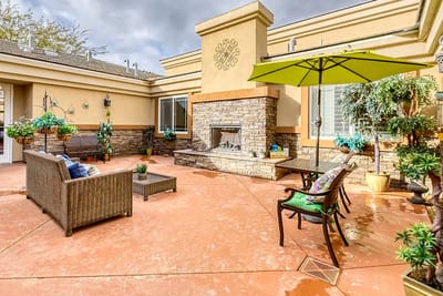 Outdoor seating area with a fireplace and plants