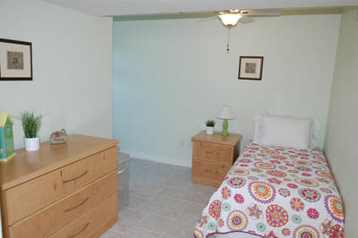 Private resident room with a bed and dresser