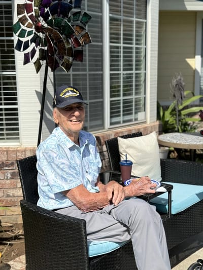 Elderly man enjoying time outdoors in a garden area